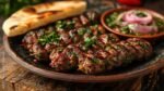 A plate of savory lamb kofta, served with pita bread.