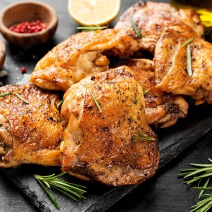 Grilled chicken thighs with spices and lemon.