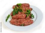 Raw lamb kofta on a plate