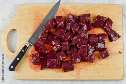 Raw liver сut into pieces on a cutting board